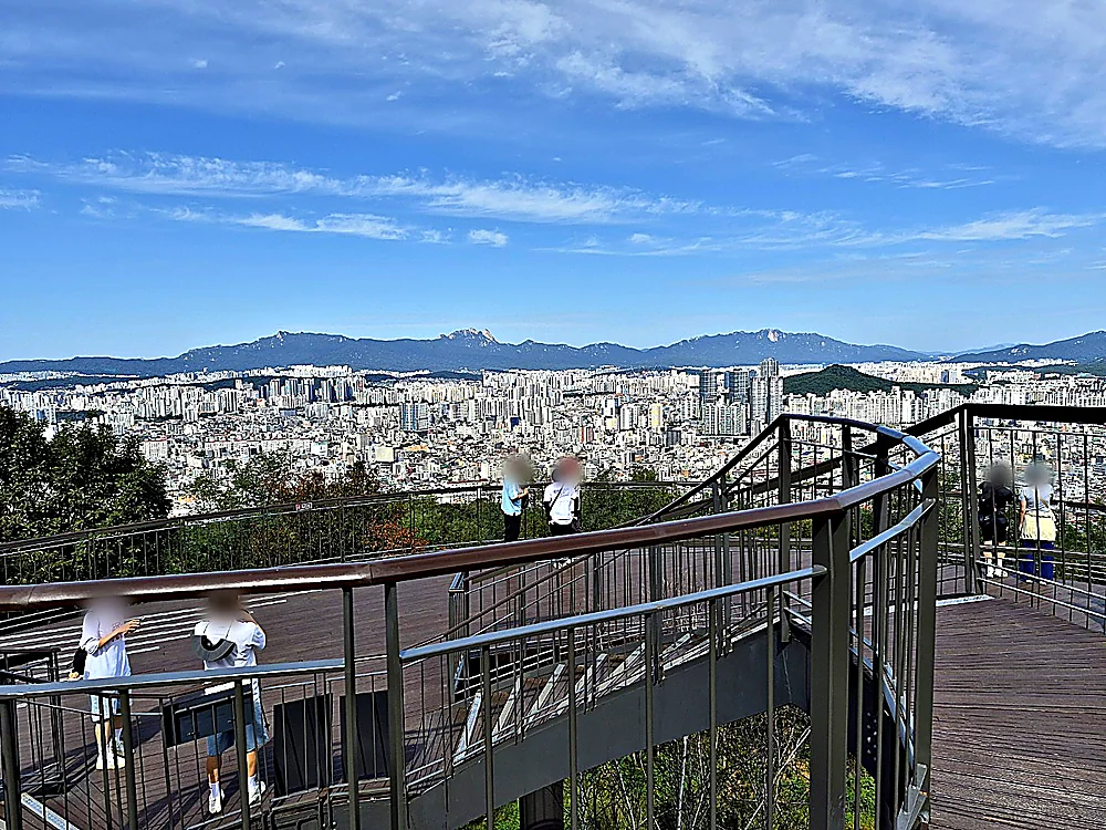 Seoul Trail Course 4: Mangu-Yongmasan 13 Yongmasan Skywalk with Seoul apartments and the Bukhansan ridge on the horizon